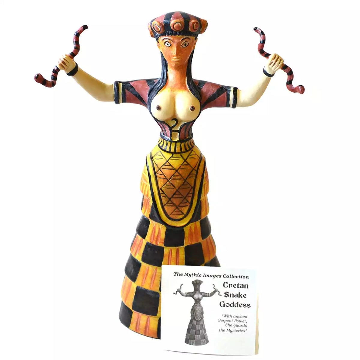 Cretan Snake Goddess statue: a painted figure with raised arms and a snake in each hand, a banded crown, and a black and yellow checked skirt, with a small card reading Cretan Snake Goddess.