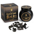 Black jar of Sonavi Sandal Oud bakhoor incense chips with gold label, next to its decorative box with intricate designs, and small oud wood pieces scattered in front — 40g natural sandalwood and agarwood grounding blend.