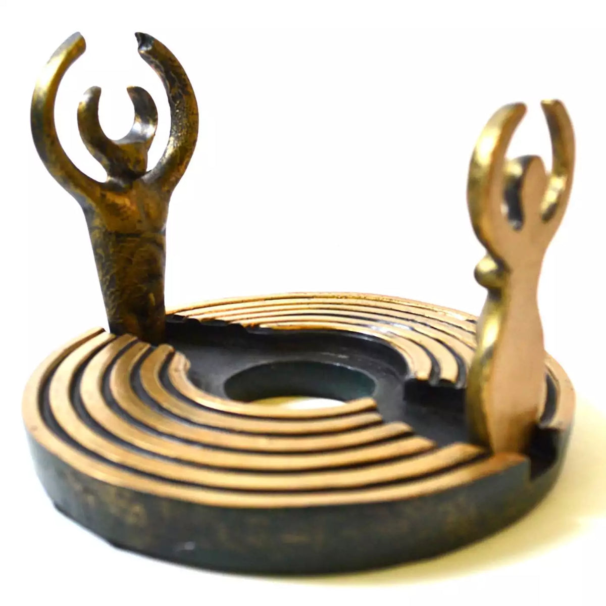 Dearinth Mini Altar: a round bronze-toned labyrinth base of concentric raised ridges with two upright cut-out figures, the Goddess and the God, arms raised in crescents, around an open center.
