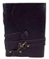 5x7 black genuine leather journal with embossed floral pattern, secured with a decorative cord and compass-style key closure, shown closed on a neutral background.