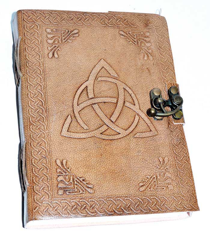5x7 inch leather-bound journal with embossed triquetra Celtic knot design on the cover and metal latch closure, filled with handmade paper for grimoire and ritual writing.