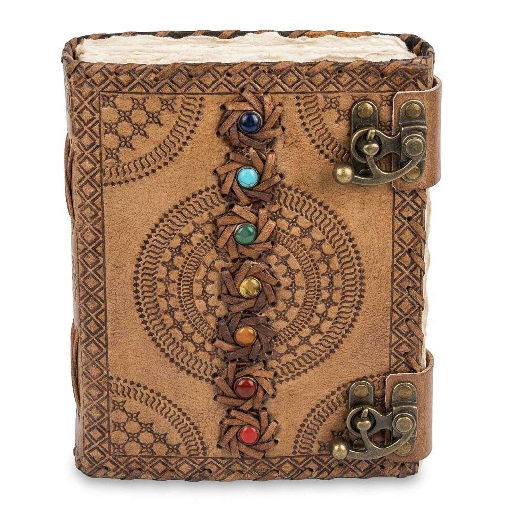 Handcrafted leather journal with intricate embossed patterns and colorful gemstones along the spine — secured with decorative brass clasps.
