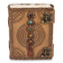 Handcrafted leather journal with intricate embossed patterns and colorful gemstones along the spine — secured with decorative brass clasps.