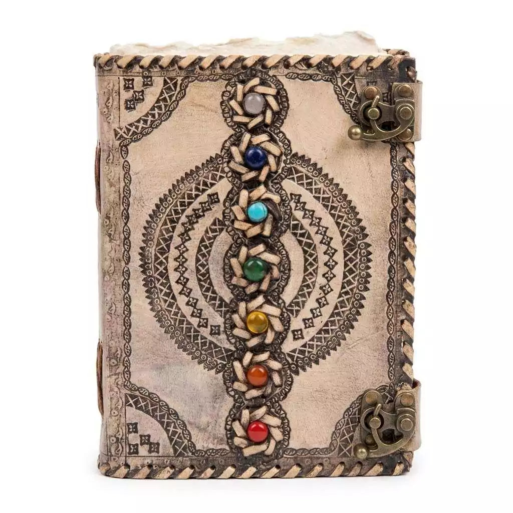 Decorative leather-bound journal with chakra gemstone inlays and intricate tooled patterns on the cover — dual metal clasp closure.