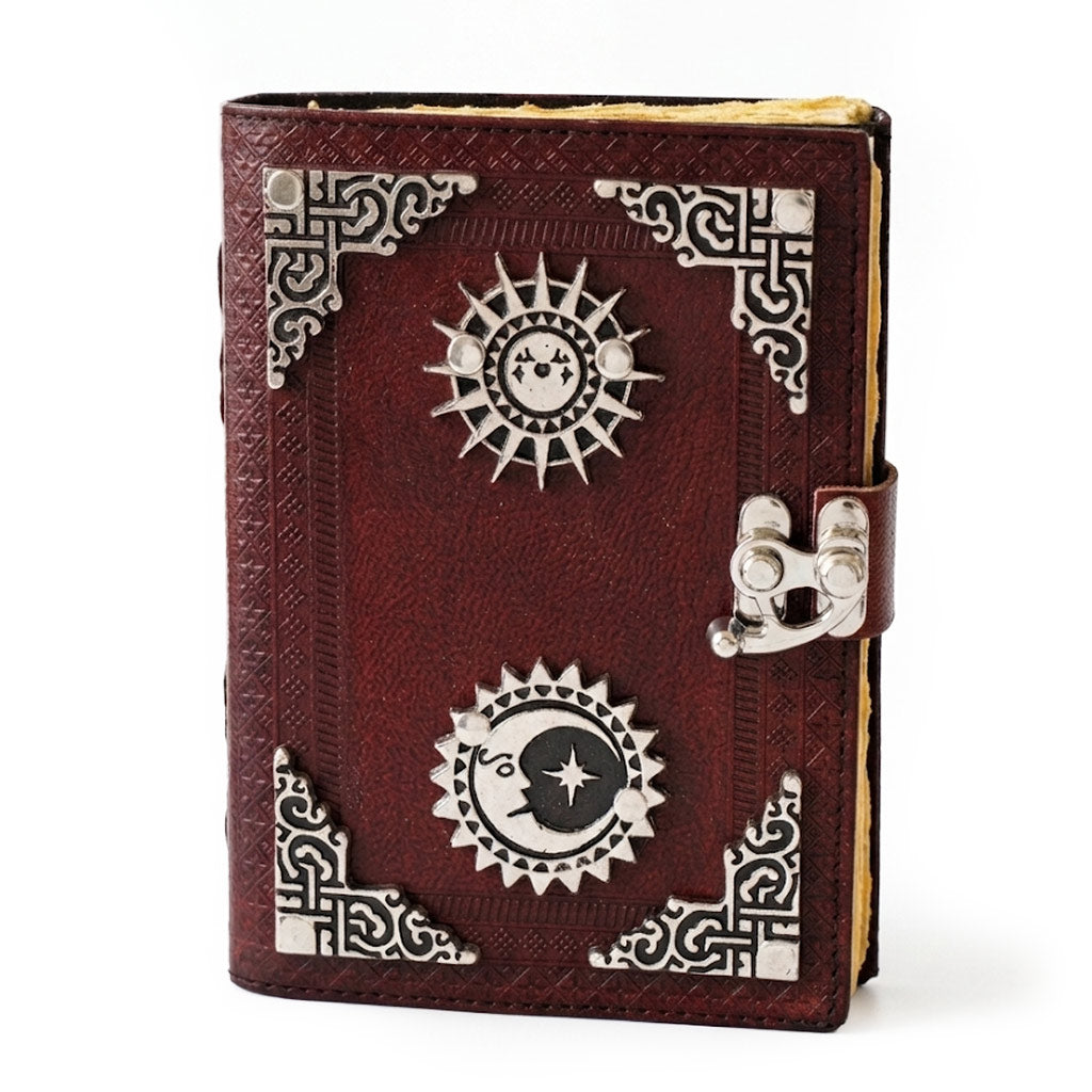 A decorative red leather-bound book with silver embellishments and a clasp, featuring intricate designs on the cover. The book appears to have a mystical or vintage style.