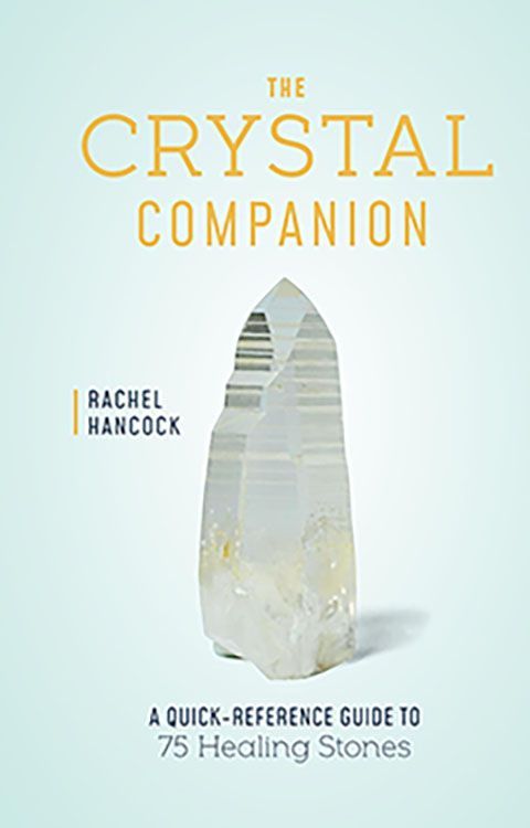 Clear quartz crystal standing upright against a light blue background beside the title The Crystal Companion Quick-Reference Guide to 75 Healing Stones
