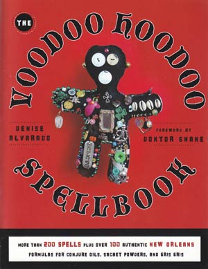 Voodoo Hoodoo Spellbook cover featuring a colorful voodoo doll adorned with charms and buttons against a striking red background.
