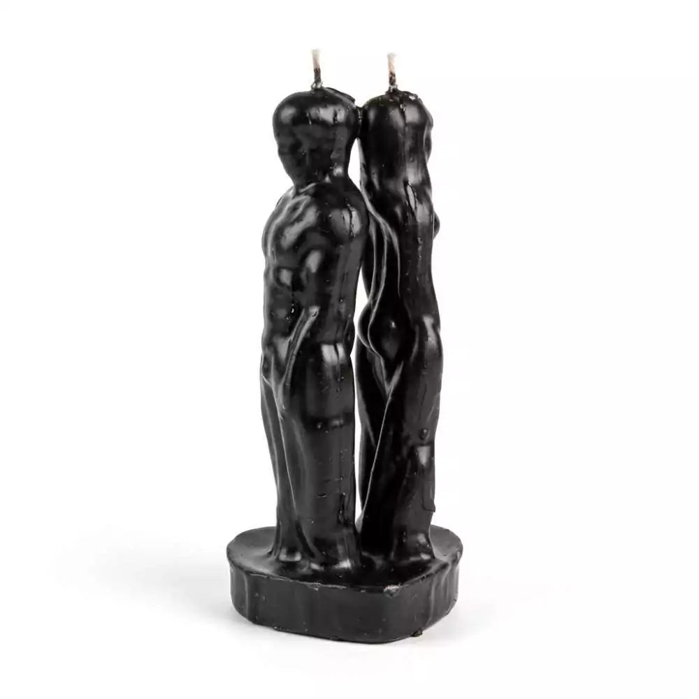Pair of black figure candles shaped as a man and woman standing back to back on a shared base — 7-inch dual-figure separation candle for cord-cutting rituals.