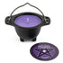 Small black cast iron cauldron holding a purple lavender-scented candle, with a circular pentagram label on the front.