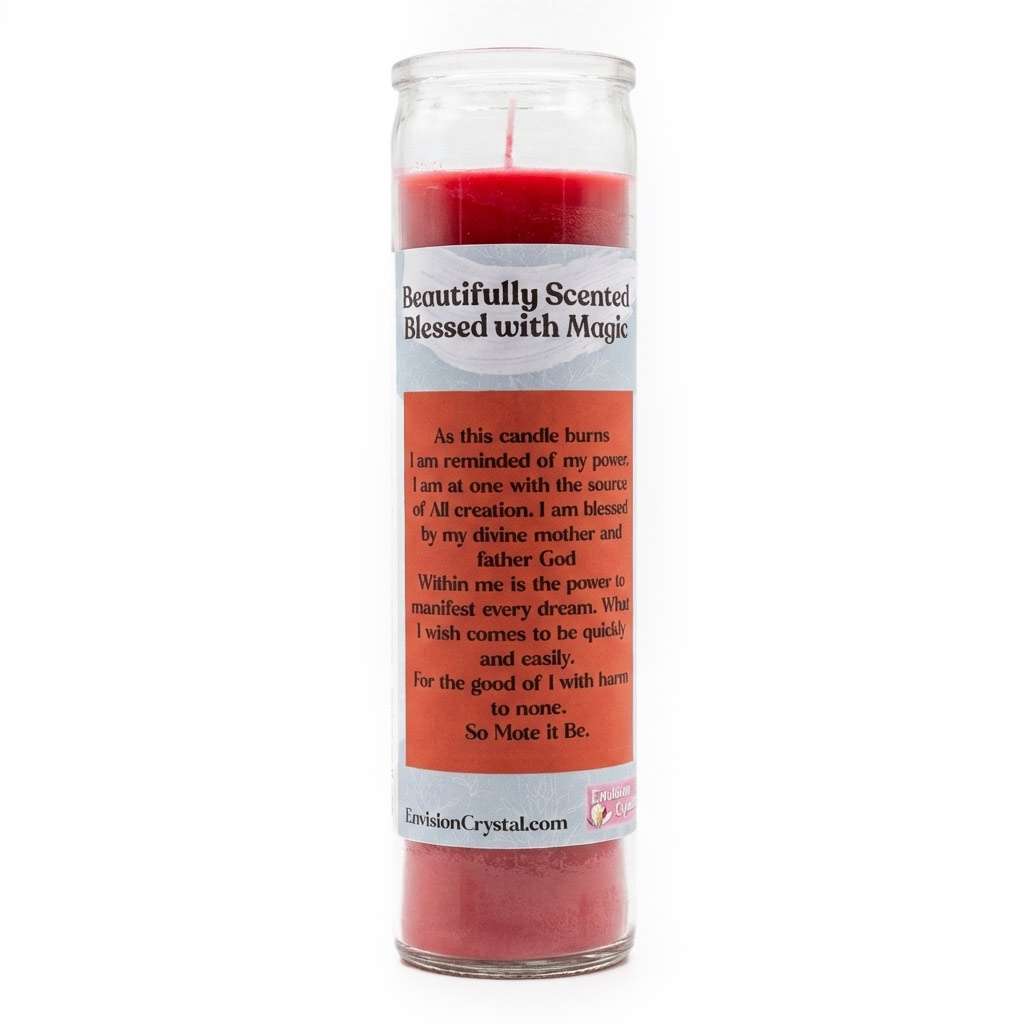Red scented candle in clear glass container with Magical Manifestation label burning in atmospheric candlelit setting