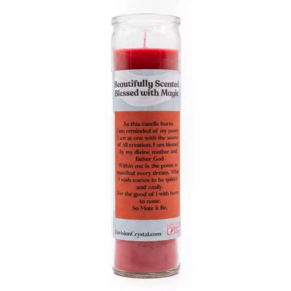 Red scented candle in clear glass container with Magical Manifestation label burning in atmospheric candlelit setting