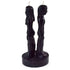 Black wax candle sculpted as two figures standing back to back, each with a wick on top, used for hoodoo separation and banishing rituals.
