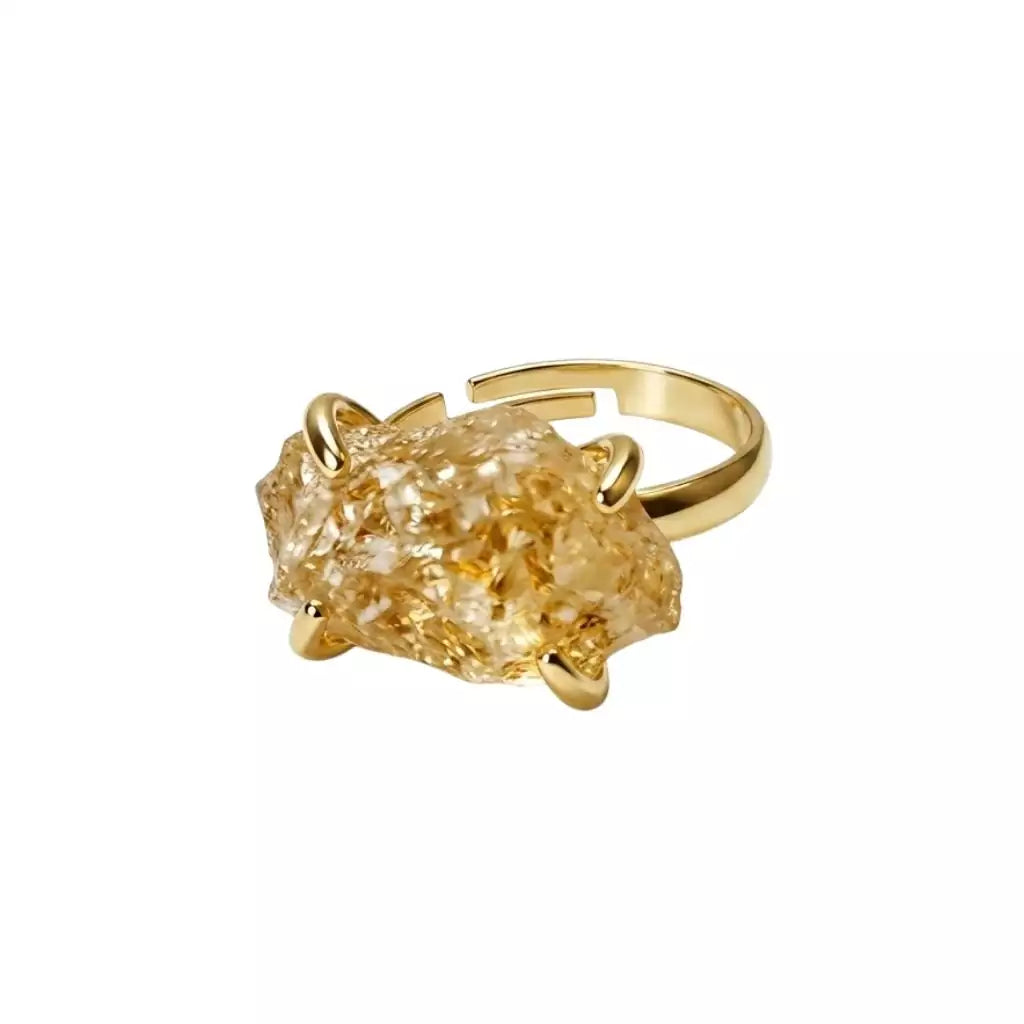 Citrine adjustable crystal ring with a warm yellow stone set on an open gold-toned band displayed on a white background