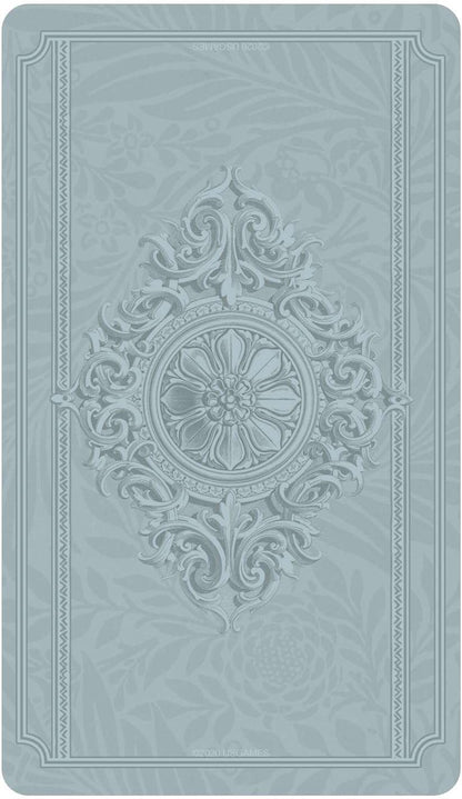 Textured embossed card back design in light blue with central floral motif from the Dreamkeepers Tarot deck.