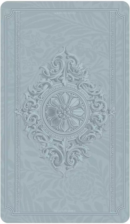 Textured embossed card back design in light blue with central floral motif from the Dreamkeepers Tarot deck.