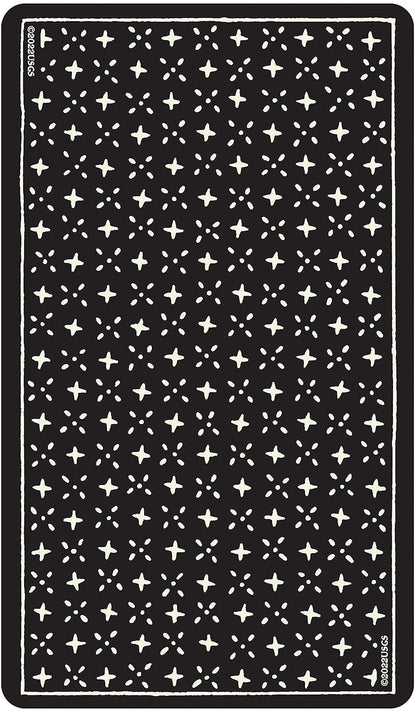 Dark surface showing the back design of the Glow in the Dark Tarot cards — a repeating pattern of small white stars on black.