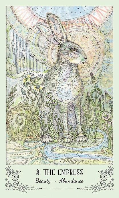 Spiritsong Tarot card featuring a rabbit adorned with intricate patterns surrounded by a lush flowering landscape.