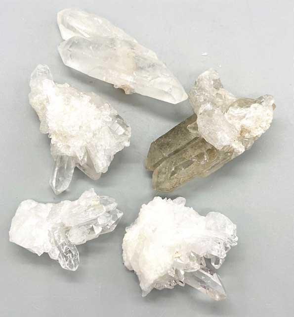 1 lb natural quartz crystal cluster collection showing multi-point clear quartz formations in various sizes for grids and altar work.