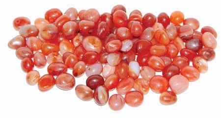 One-pound collection of smooth vivid orange carnelian tumbled chalcedony stones for sacral chakra creativity courage motivation and empowerment rituals