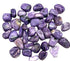 A pile of polished charoite tumbled stones in rich swirling violet and lavender patterns, the rare Siberian crystal, sold in 1 lb bulk lots.
