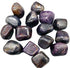 A collection of corundum tumbled stones in grey and brown metallic tones, shown in a 1 lb bulk lot for crystal grids and altar work.