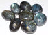 Large 2-inch polished labradorite tumbled stones in pile showing vivid blue and green labradorescence flash, one pound bulk lot