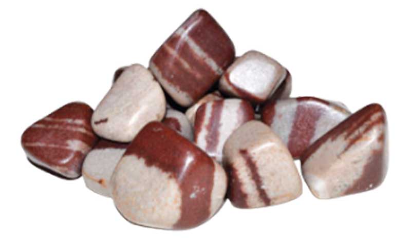 A collection of smooth, polished stones in shades of red and white, arranged in a small pile.