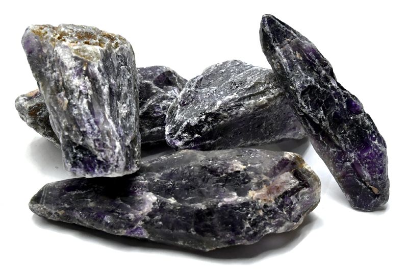 A collection of rough purple stones with varying textures and sizes, showcasing their natural mineral formations.