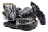 A collection of rough purple stones with varying textures and sizes, showcasing their natural mineral formations.