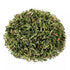 Dried herbs piled in a mound, showcasing a mix of green leaves and stems.