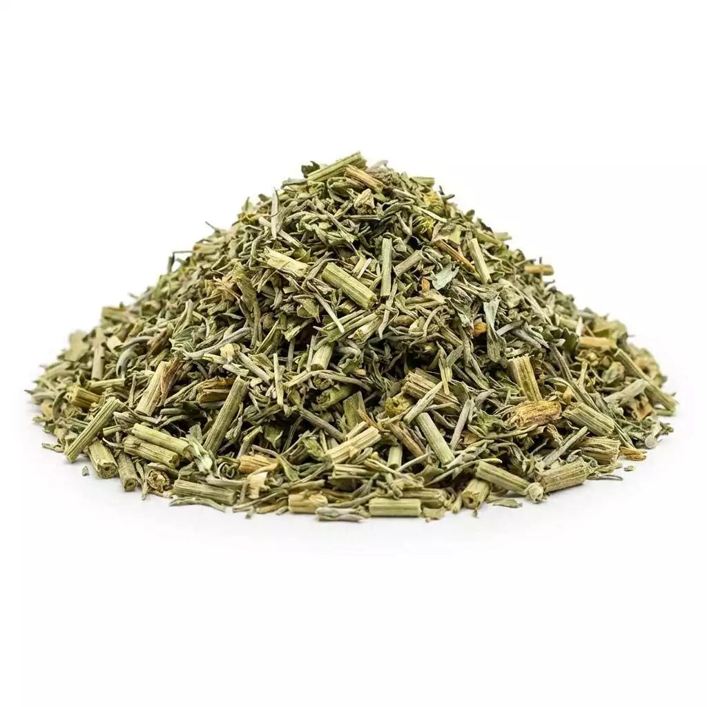 Dried wormwood (Artemisia absinthium) cut herb in a pile showing finely chopped green herb texture, ritual botanical ingredient