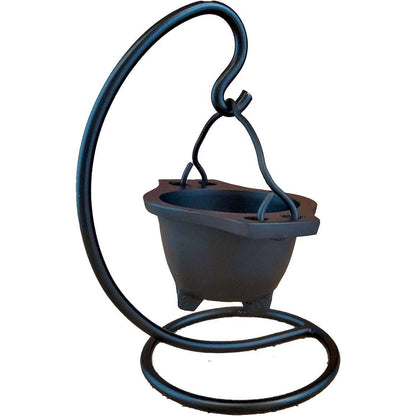 Black cast iron hanging cauldron on a curved iron stand — showing the suspended ritual cauldron in full-height display for altar use.