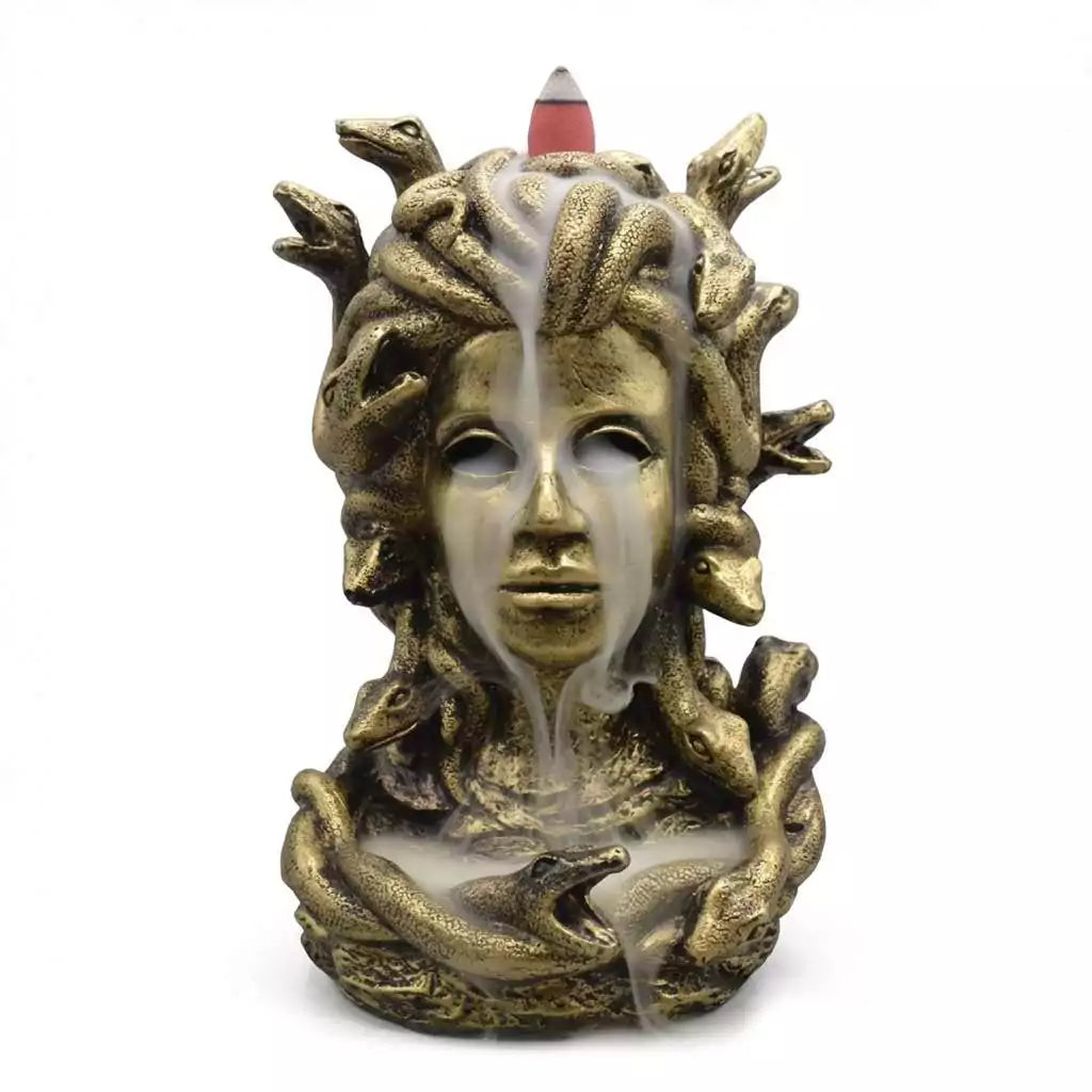 Detailed resin sculpture of Medusa with snakes for hair designed as backflow incense burner with atmospheric smoke cascading
