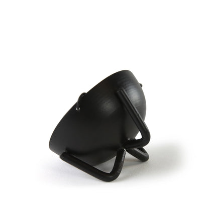 Black curved iron incense burner piece on a stand showing simple modern profile of the hanging bowl support arm.