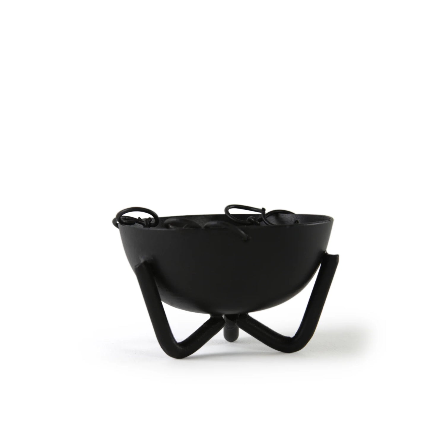Black iron incense bowl with wide rim and three curved legs — showing the bowl&