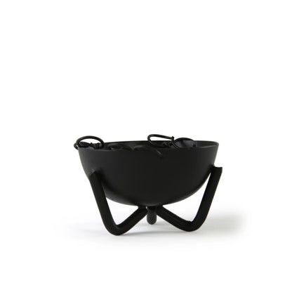 Black iron incense bowl with wide rim and three curved legs — showing the bowl&
