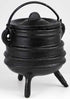 Small classic black ribbed cast iron cauldron with lid and three legs, shown on white background as a traditional altar ritual vessel