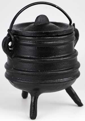 Small classic black ribbed cast iron cauldron with lid and three legs, shown on white background as a traditional altar ritual vessel