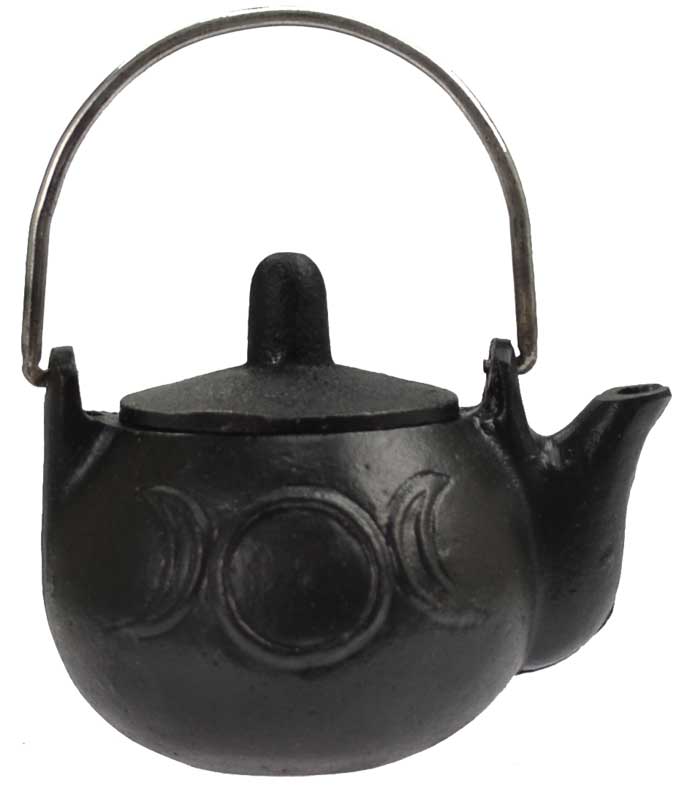 Small black cast iron cauldron with rounded body and handle featuring embossed crescent moon designs, three-legged base shown on white background