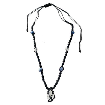 Handmade cord necklace with a central clear and blue sodalite pendant surrounded by beads on a black adjustable cord.