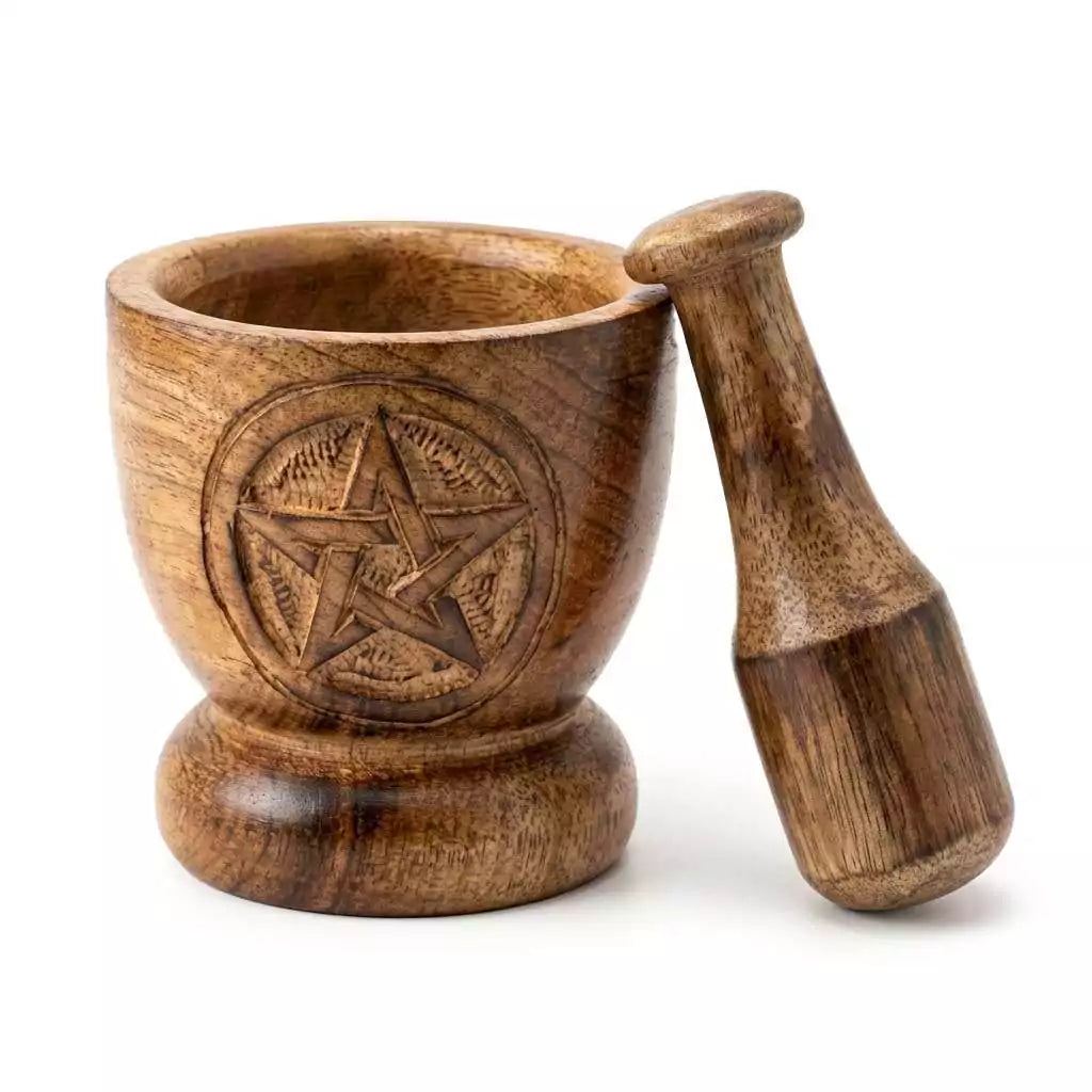 Wooden mortar and pestle with carved pentagram design on the exterior — natural mango wood finish with sturdy round base and tapered pestle.