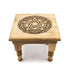 Carved wooden pentagram altar table with intricately cut five-pointed star design and raised leg platform for ritual display
