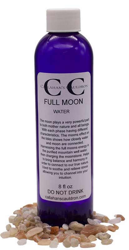 A bottle of "Full Moon Water" with a purple label, surrounded by small stones. The label describes the product&