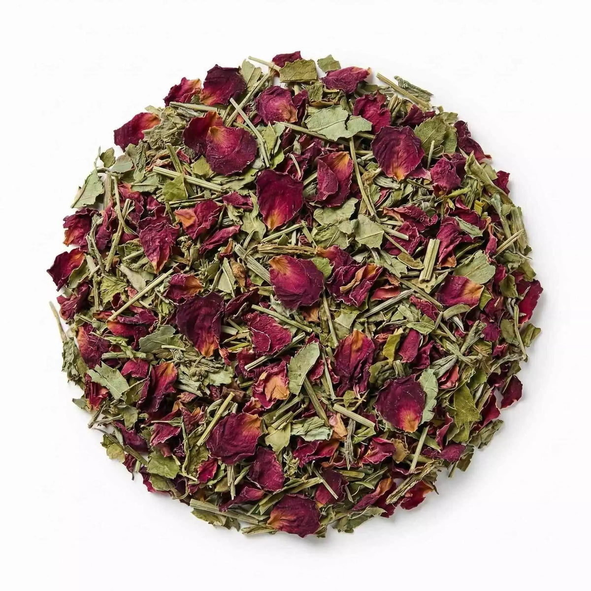 Round pile of herbal blend with red rose petals and green leaves.