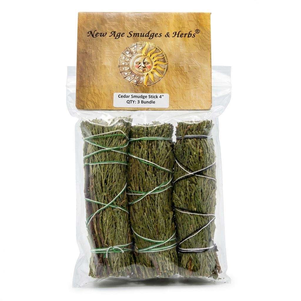 Three bundles of sage tied with string, packaged with a label featuring a sun design and the brand name "New Age Smudges &amp; Herbs."