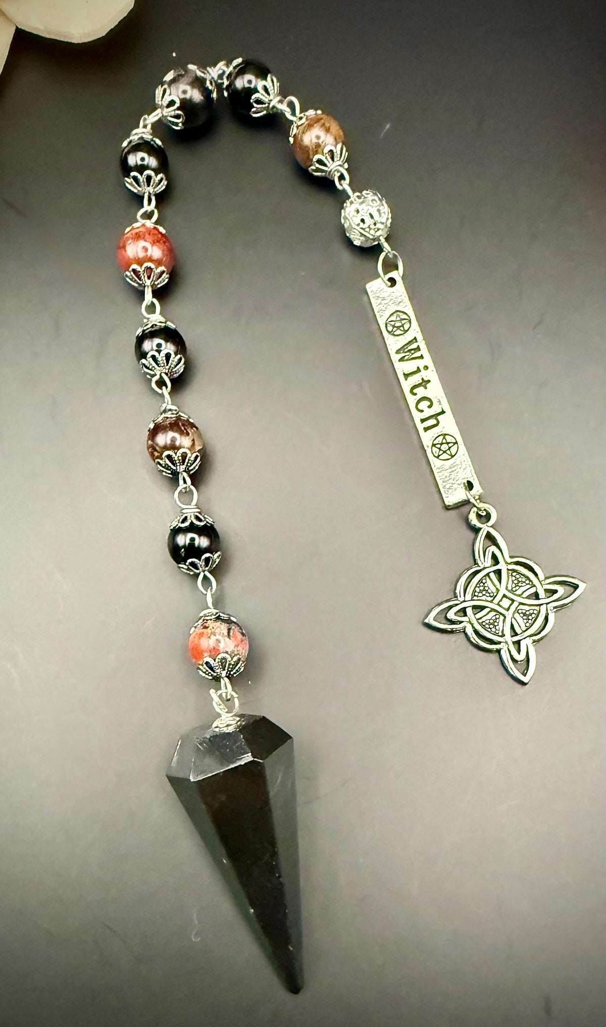 Samhain Pendulum with Tourmaline Point,  Red Brecciated Jasper, Obsidian, and Witch’s Knot Charm.