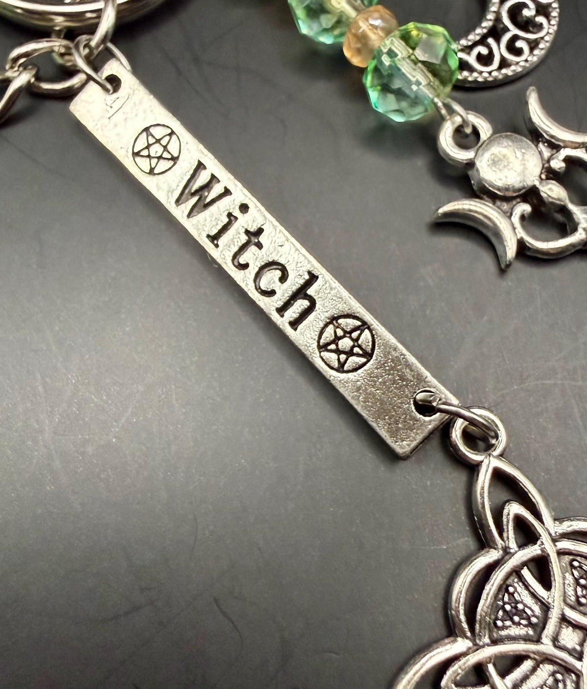 Witch Engraved Key Chain Bag Charm with Iridescent Glass Beads and Witchy Charms.