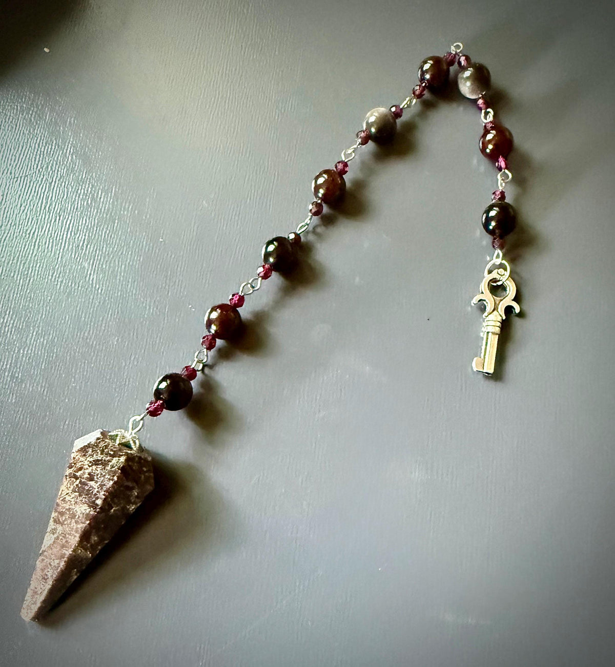 Handmade Garnet Point Pendulum with Obsidian and Garnet Beads.