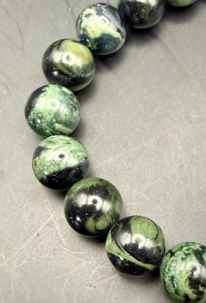 Kambaba Jasper Gemstone Stretch Bracelet with Celtic Knot Charm.