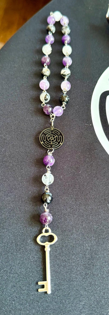 Goddess Hekate Devotional Altar Bundle with Altar Cloth, Witch’s Rosary, Pendulum , Black, and Purple Taper Candles.